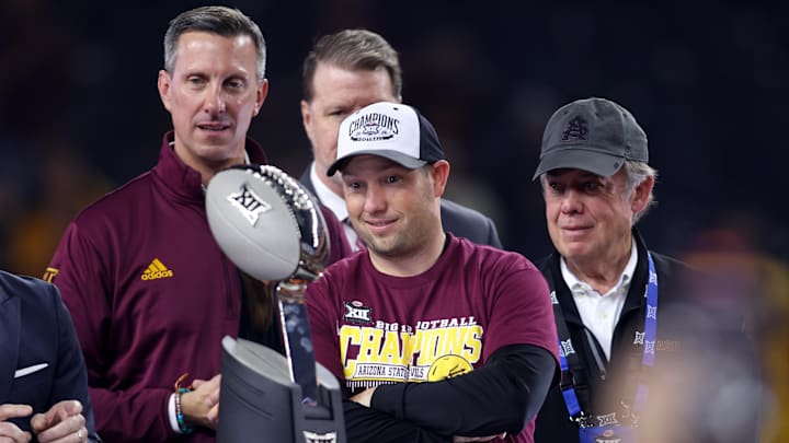Arizona State Sun Devils head coach Kenny Dillingham looks at the trophy after winning the Big 12 Championship game. Arizona State Sun Devils head coach Kenny Dillingham looks at the trophy after winning the Big 12 Championship game.