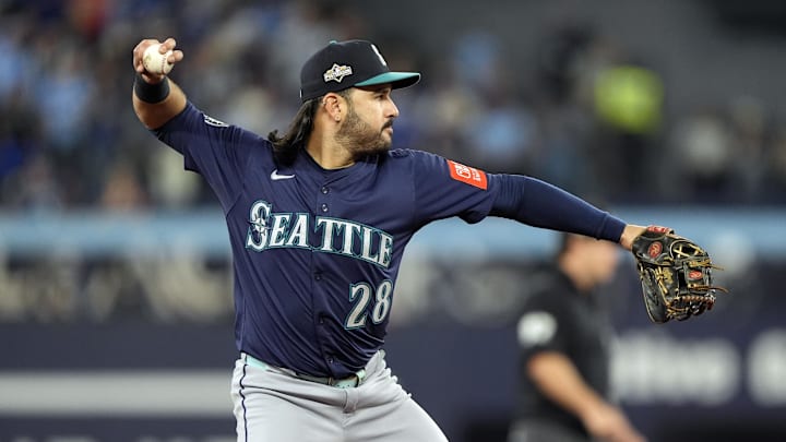 Oct 20, 2025; Toronto, Ontario, CAN; Seattle Mariners third baseman Eugenio Suarez (28) throws out Toronto Blue Jays right fielder George Springer (4) at first base in the second inning during game seven of the ALCS round for the 2025 MLB playoffs at Rogers Centre. Mandatory Credit: John E. Sokolowski-Imagn Images