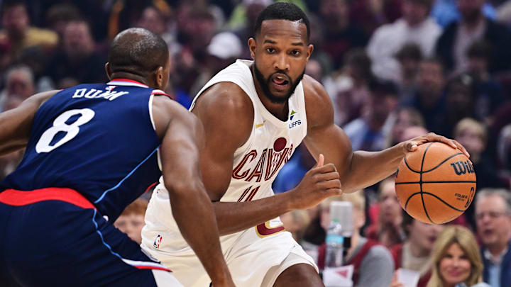 Mar 30, 2025; Cleveland, Ohio, USA; Cleveland Cavaliers forward Evan Mobley (4) drives to the basket against Los Angeles Clippers guard Kris Dunn (8) during the first quarter at Rocket Arena. Mandatory Credit: Ken Blaze-Imagn Images
