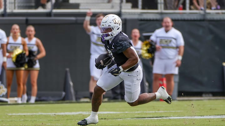 Oct 12, 2024; Orlando, Florida, USA; UCF Knights running back RJ Harvey (7) runs the ball during the first quarter against the Cincinnati Bearcats at FBC Mortgage Stadium. Mandatory Credit: Mike Watters-Imagn Images