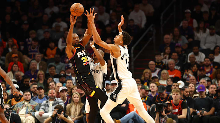 Dec 3, 2024; Phoenix, Arizona, USA; Phoenix Suns forward Kevin Durant (35) against San Antonio Spurs center Victor Wembanyama (1) in the first half of an NBA Cup game at Footprint Center. Mandatory Credit: Mark J. Rebilas-Imagn Images