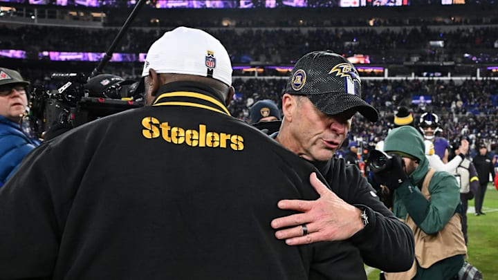 Jan 11, 2025; Baltimore, Maryland, USA; Baltimore Ravens head coach John Harbaugh embraces Pittsburgh Steelers head coach Mike Tomlin after an AFC wild card game at M&T Bank Stadium. Mandatory Credit: Tommy Gilligan-Imagn Images