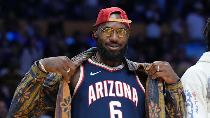 Oct 24, 2025; Los Angeles, California, USA; Los Angeles Lakers forward LeBron James poses in the Arizona Wildcats jersey of his son Bryce James (6) during the game against the Minnesota Timberwolves at Crypto.com Arena. Mandatory Credit: Kirby Lee-Imagn Images