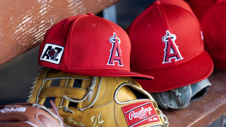 Feb 28, 2025; Phoenix, Arizona, USA; Detailed view of the Los Angeles Angels logo on a hat in the dugout during a spring training game at Camelback Ranch-Glendale. Mandatory Credit: Mark J. Rebilas-Imagn Images