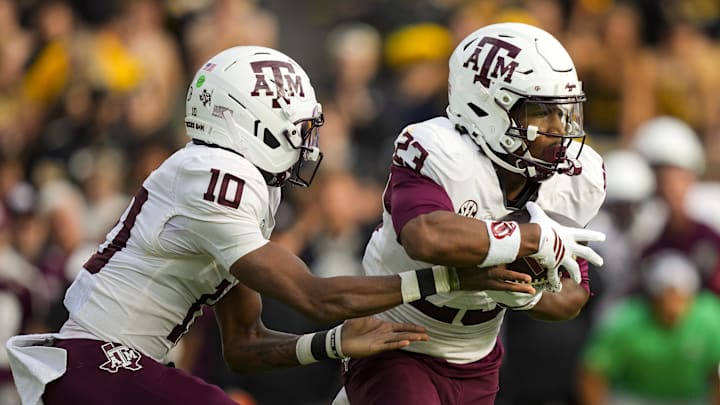 Texas A&M Aggies running back Jamarion Morrow (23) takes the handoff from quarterback Marcel Reed (10) during the first half against the Missouri Tigers at Faurot Field at Memorial Stadium. Texas A&M Aggies running back Jamarion Morrow (23) takes the handoff from quarterback Marcel Reed (10) during the first half against the Missouri Tigers at Faurot Field at Memorial Stadium.