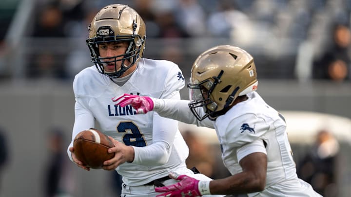 Pope John's Luke Irwin (2) hands the ball off to Tylik Hill (3) during the NJSIAA Non-Public B high school football championship game between DePaul and Pope John on Friday, Nov. 29 at MetLife Stadium.