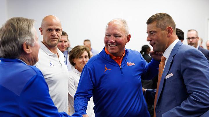 Florida Gators booster Gary Condron shakes hands with former head coach Steve Spurrier and Florida Gators head coach Jon Sumrall, while former quarterback Danny Wuerffel watches. Florida Gators booster Gary Condron shakes hands with former head coach Steve Spurrier and Florida Gators head coach Jon Sumrall, while former quarterback Danny Wuerffel watches.