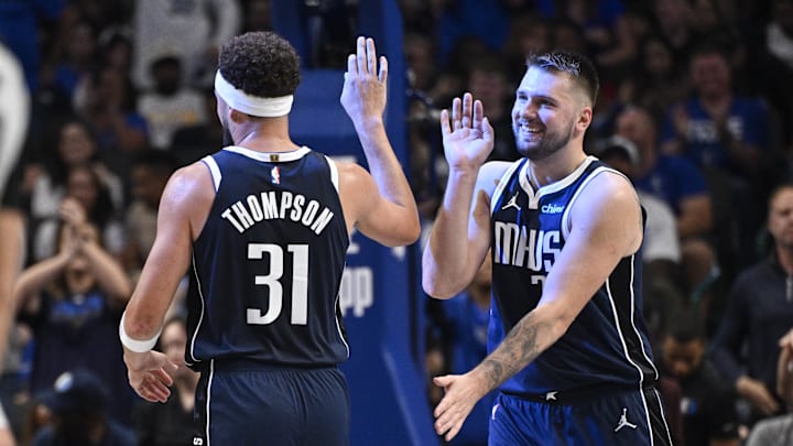 Luka Doncic and Klay Thompson enjoy a high five. 