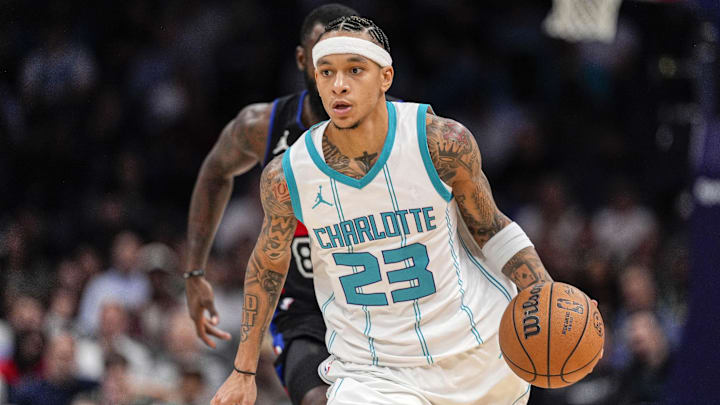 Nov 6, 2024; Charlotte, North Carolina, USA;  Charlotte Hornets guard Tre Mann (23) handles the ball against the Detroit Pistons during the second half at Spectrum Center. Mandatory Credit: Jim Dedmon-Imagn Images
