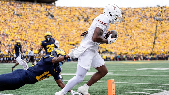 Texas wide receiver Matthew Golden (2) scores a touchdown against Michigan defensive back Aamir Hall (12) during the first half at Michigan Stadium in Ann Arbor on Saturday, September 7, 2024. Texas wide receiver Matthew Golden (2) scores a touchdown against Michigan defensive back Aamir Hall (12) during the first half at Michigan Stadium in Ann Arbor on Saturday, September 7, 2024.