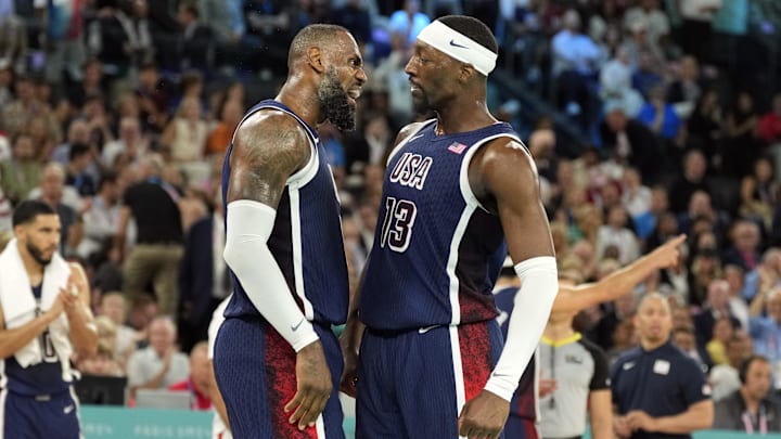Aug 10, 2024; Paris, France; United States guard LeBron James (6) and centre Bam Adebayo (13) react in the first half against France in the men's basketball gold medal game during the Paris 2024 Olympic Summer Games at Accor Arena. Mandatory Credit: Kyle Terada-Imagn Images