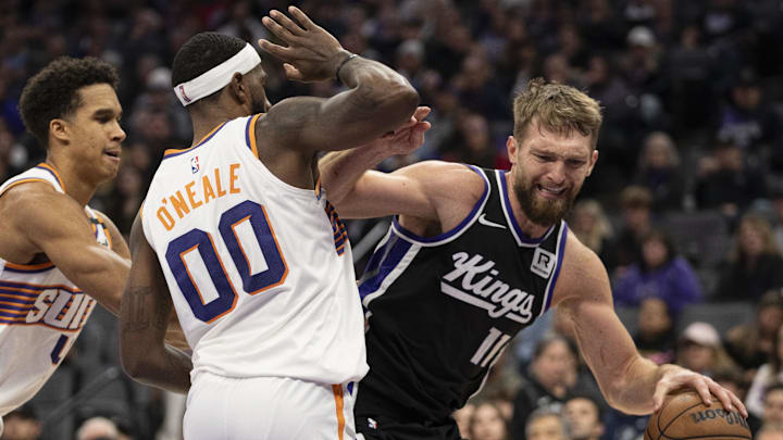 November 13, 2024; Sacramento, California, USA; Sacramento Kings forward Domantas Sabonis (11) is defended by Phoenix Suns forward Royce O'Neale (00) during the second quarter at Golden 1 Center. Mandatory Credit: Kyle Terada-Imagn Images November 13, 2024; Sacramento, California, USA; Sacramento Kings forward Domantas Sabonis (11) is defended by Phoenix Suns forward Royce O'Neale (00) during the second quarter at Golden 1 Center. Mandatory Credit: Kyle Terada-Imagn Images