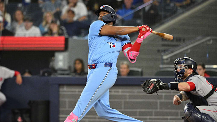 Sep 24, 2024; Toronto, Ontario, CAN; Toronto Blue Jays designated hitter Vladimir Guerrero Jr. (27) hits a two run RBI double against the Boston Red Sox in the third inning at Rogers Centre. Mandatory Credit: Dan Hamilton-Imagn Images