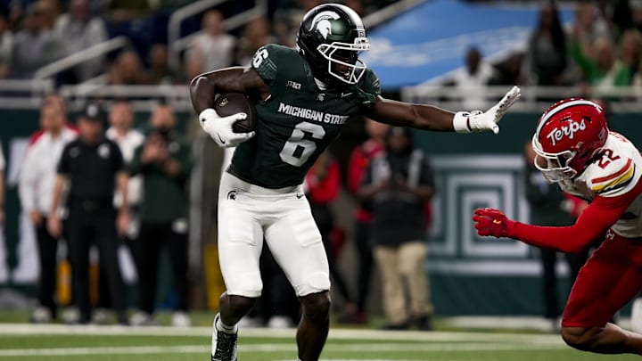 Nov 29, 2025; Detroit, Michigan, USA; Michigan State wide receiver Nick Marsh (6) stiff arms Maryland defensive back Jalen Huskey (22) in the second quarter at Ford Field. Mandatory Credit: Brendan Mullin-Imagn Images