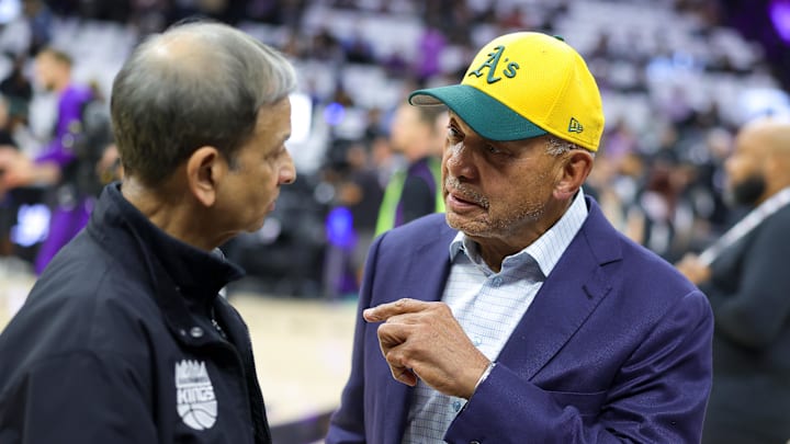 Oct 24, 2024; Sacramento, California, USA; Major League Baseball hall of famer Reggie Jackson speaks with Sacramento Kings chairman Vivek Ranadivé  before the game against the Minnesota Timberwolves at Golden 1 Center. Mandatory Credit: Sergio Estrada-Imagn Images