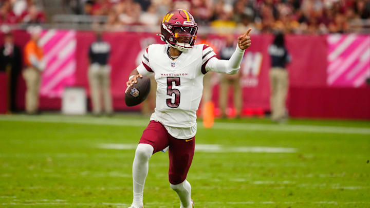 Commanders quarterback Jayden Daniels (5) looks for open receivers against the Cardinals during a game at State Farm Stadium in Glendale on Sept. 29, 2024.