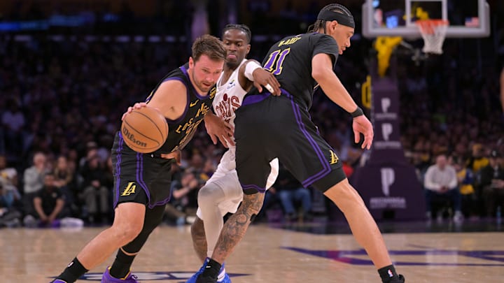 Mar 31, 2026; Los Angeles, California, USA;  Los Angeles Lakers center Jaxson Hayes (11) screens Cleveland Cavaliers guard Keon Ellis (14) as Los Angeles Lakers guard Luka Doncic (77) drives to the basket in the first half at Crypto.com Arena. Mandatory Credit: Jayne Kamin-Oncea-Imagn Images