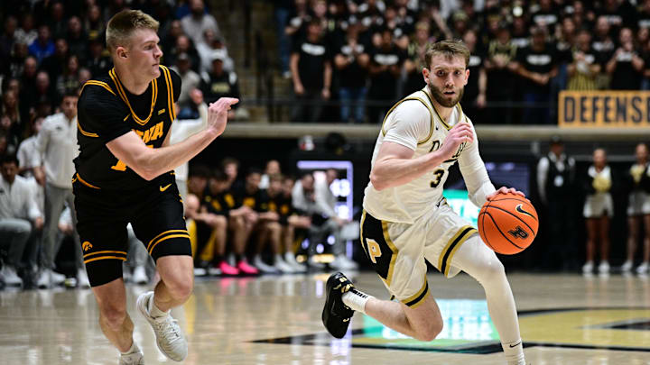Purdue Boilermakers guard Braden Smith (3) drives past Iowa Hawkeyes guard Bennett Stirtz (14).