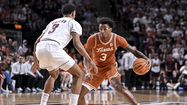 Texas Longhorns guard Dailyn Swain controls the ball during the first half as Texas A&M Aggies guard Rylan Griffen defends at Reed Arena. 