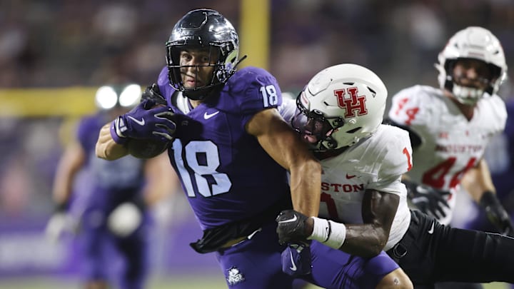 Oct 4, 2024; Fort Worth, Texas, USA; TCU Horned Frogs wide receiver Jack Bech (18) breaks the tackle of Houston Cougars defensive back Latrell McCutchin Sr. (1) and scores a touchdown in the fourth quarter at Amon G. Carter Stadium. Mandatory Credit: Tim Heitman-Imagn Images Oct 4, 2024; Fort Worth, Texas, USA; TCU Horned Frogs wide receiver Jack Bech (18) breaks the tackle of Houston Cougars defensive back Latrell McCutchin Sr. (1) and scores a touchdown in the fourth quarter at Amon G. Carter Stadium. Mandatory Credit: Tim Heitman-Imagn Images