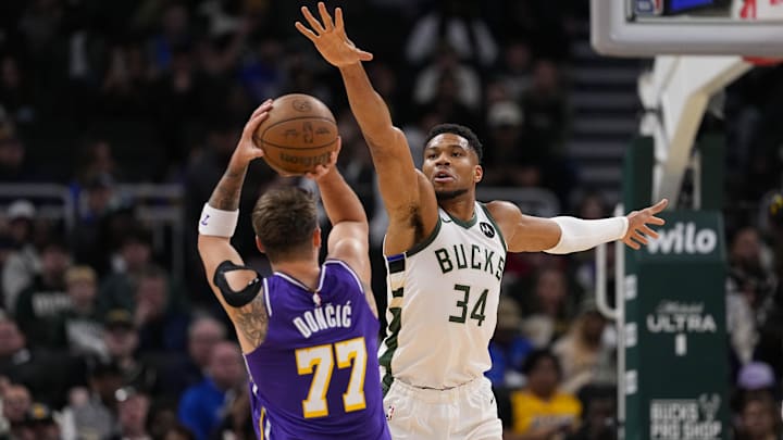 Nov 15, 2025; Milwaukee, Wisconsin, USA;  Milwaukee Bucks forward Giannis Antetokounmpo (34) defends Los Angeles Lakers guard Luka Doncic (77) during the first quarter at Fiserv Forum. Mandatory Credit: Jeff Hanisch-Imagn Images