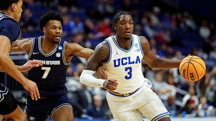 Mar 20, 2025; Lexington, KY, USA;  UCLA Bruins guard Eric Dailey Jr. (3) drives to the basket against Utah State Aggies guard Dexter Akanno (7) during the second half in the first round of the NCAA Tournament at Rupp Arena. Mandatory Credit: Jordan Prather-Imagn Images