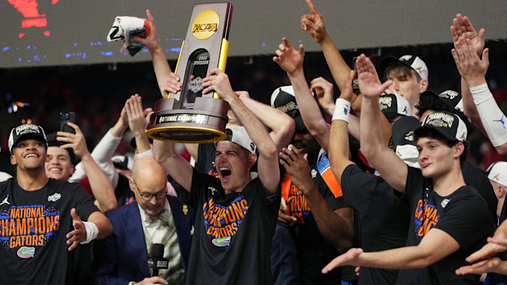 Apr 7, 2025; San Antonio, TX, USA; Florida Gators head coach Todd Golden holds up the trophy after winning the national championship game of the Final Four of the 2025 NCAA Tournament at the Alamodome. Mandatory Credit: Bob Donnan-Imagn Images Apr 7, 2025; San Antonio, TX, USA; Florida Gators head coach Todd Golden holds up the trophy after winning the national championship game of the Final Four of the 2025 NCAA Tournament at the Alamodome. Mandatory Credit: Bob Donnan-Imagn Images