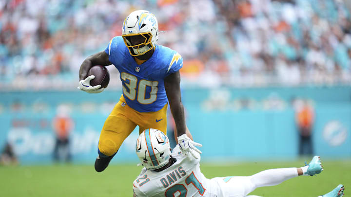 Oct 12, 2025; Miami Gardens, Florida, USA; Miami Dolphins safety Ashtyn Davis (21) tackles Los Angeles Chargers running back Kimani Vidal (30) during the second quarter at Hard Rock Stadium. Mandatory Credit: Rich Storry-Imagn Images Oct 12, 2025; Miami Gardens, Florida, USA; Miami Dolphins safety Ashtyn Davis (21) tackles Los Angeles Chargers running back Kimani Vidal (30) during the second quarter at Hard Rock Stadium. Mandatory Credit: Rich Storry-Imagn Images