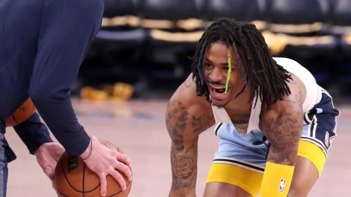 Apr 19, 2022; Memphis, Tennessee, USA; Memphis Grizzlies guard Ja Morant (12) practices during warm-ups before game two of the first round for the 2022 NBA playoffs at FedExForum. Apr 19, 2022; Memphis, Tennessee, USA; Memphis Grizzlies guard Ja Morant (12) practices during warm-ups before game two of the first round for the 2022 NBA playoffs at FedExForum.