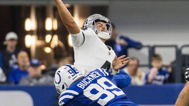 Dec 31, 2023; Indianapolis, Indiana, USA; Las Vegas Raiders quarterback Aidan O'Connell (4) passes the ball while Indianapolis Colts defensive tackle DeForest Buckner (99) defends in the first half at Lucas Oil Stadium. Mandatory Credit: Trevor Ruszkowski-USA TODAY Sports