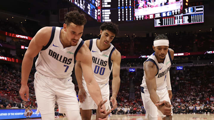 Mar 14, 2025; Houston, Texas, USA; Dallas Mavericks forward Naji Marshall (13) is helped off the floor by center Dwight Powell (7) and guard Max Christie (00) after being fouled by the Houston Rockets in the second half at Toyota Center. Mandatory Credit: Thomas Shea-Imagn Images Mar 14, 2025; Houston, Texas, USA; Dallas Mavericks forward Naji Marshall (13) is helped off the floor by center Dwight Powell (7) and guard Max Christie (00) after being fouled by the Houston Rockets in the second half at Toyota Center. Mandatory Credit: Thomas Shea-Imagn Images