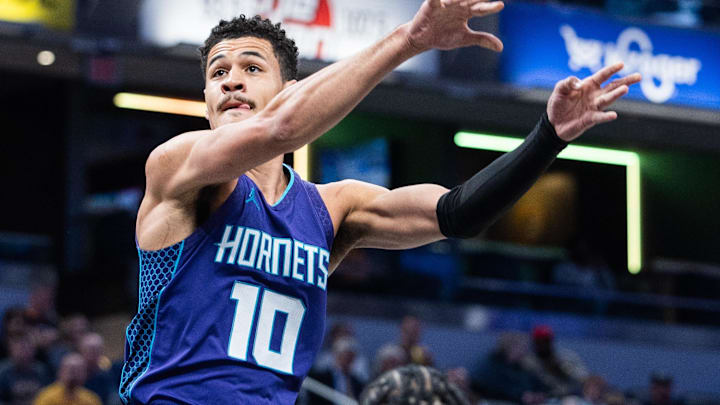 Apr 2, 2025; Indianapolis, Indiana, USA; Charlotte Hornets guard Josh Green (10) passes the ball while Indiana Pacers forward Aaron Nesmith (23) defends in the first half at Gainbridge Fieldhouse. Mandatory Credit: Trevor Ruszkowski-Imagn Images