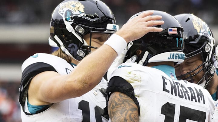 Dec 10, 2023; Cleveland, Ohio, USA; Jacksonville Jaguars quarterback Trevor Lawrence (16) congratulates tight end Evan Engram (17) on his touchdown during the second quarter at Cleveland Browns Stadium. Mandatory Credit: Scott Galvin-Imagn Images