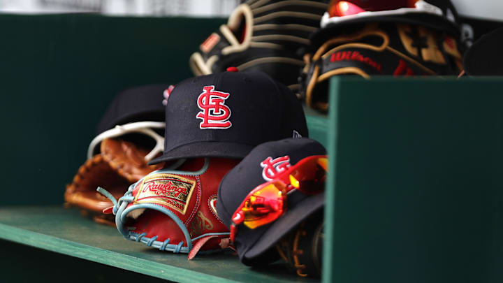 Apr 24, 2022; Cincinnati, Ohio, USA; A view of St. Louis Cardinals players    hats and gloves in the dugout during a game with the Cincinnati Reds at Great American Ball Park. Mandatory Credit: David Kohl-Imagn Images