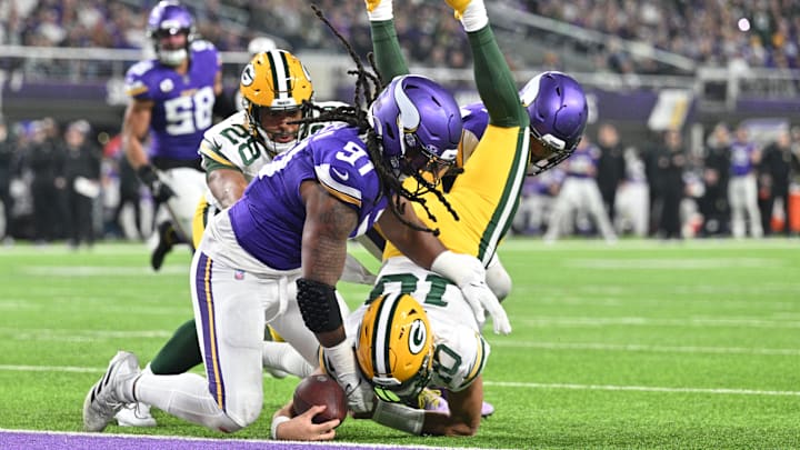 Green Bay Packers quarterback Jordan Love scores on a touchdown run as Minnesota Vikings linebacker Pat Jones II (91) and safety Camryn Bynum defend during the second quarter at U.S. Bank Stadium in Minneapolis on Dec. 31, 2023. Green Bay Packers quarterback Jordan Love scores on a touchdown run as Minnesota Vikings linebacker Pat Jones II (91) and safety Camryn Bynum defend during the second quarter at U.S. Bank Stadium in Minneapolis on Dec. 31, 2023.