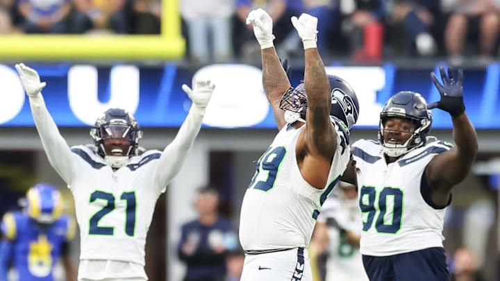 Jan 5, 2025; Inglewood, California, USA;  Seattle Seahawks Defensive End Leonard Williams (99), Free Safety Devon Witherspoon (21) and Nose Tackle Jarred Reed (90) celebrate a 4th down stop at SoFi Stadium, as the Seattle Seahawks face off versus the Los Angeles Rams Week 18 matchup. Mandatory Credit: William Navarro-Imagn Images