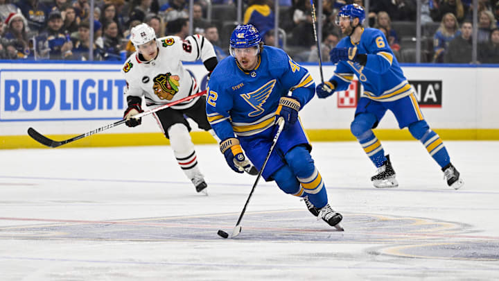 Dec 23, 2023; St. Louis, Missouri, USA;  St. Louis Blues right wing Kasperi Kapanen (42) controls the puck against the Chicago Blackhawks during the second period at Enterprise Center. Mandatory Credit: Jeff Curry-Imagn Images