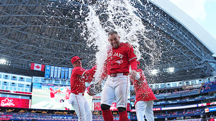 Jul 1, 2025; Toronto, Ontario, CAN; Toronto Blue Jays right fielder George Springer (4) gets the water bucket poured on him at the end of the ninth inning against the New York Yankees at Rogers Centre. Mandatory Credit: Nick Turchiaro-Imagn Images