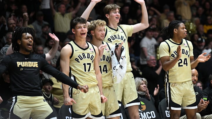 The Purdue Boilermakers bench celebrates a basket 