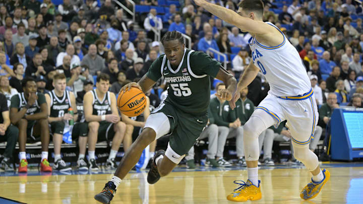 Feb 4, 2025; Los Angeles, California, USA; Michigan State Spartans forward Coen Carr (55) is defended by UCLA Bruins guard Lazar Stefanovic (10) in the second half at Pauley Pavilion presented by Wescom. Mandatory Credit: Jayne Kamin-Oncea-Imagn Images