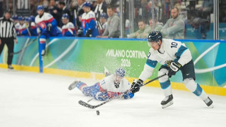 Feb 21, 2026; Milan, Italy; Milos Kelemen (11) of Slovakia and Henri Jokiharju (10) of Finland battle for the puck in the second period in the men's ice hockey bronze medal game during the Milano Cortina 2026 Olympic Winter Games at Milano Santagiulia Ice Hockey Arena. Mandatory Credit: Joe Camporeale-Imagn Images