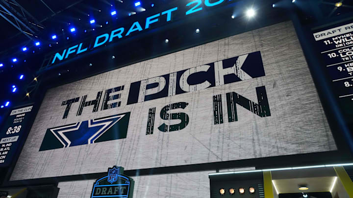 The Dallas Cowboys logo is projected on the video board during the NFL Draft at Lambeau Field. 
