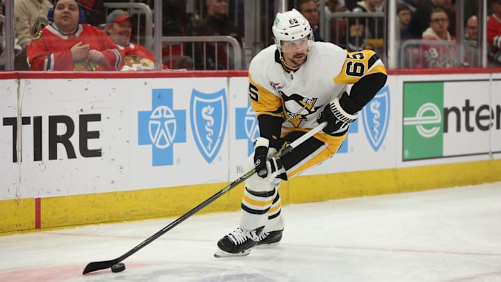 Apr 6, 2025; Chicago, Illinois, USA; Pittsburgh Penguins defenseman Erik Karlsson (65) clears the puck during the first period against the Chicago Blackhawks at United Center. Mandatory Credit: Talia Sprague-Imagn Images Apr 6, 2025; Chicago, Illinois, USA; Pittsburgh Penguins defenseman Erik Karlsson (65) clears the puck during the first period against the Chicago Blackhawks at United Center. Mandatory Credit: Talia Sprague-Imagn Images