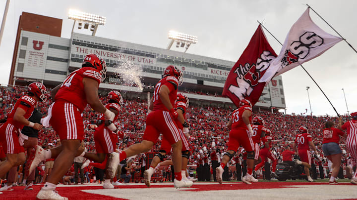 The Utah Utes enter the field before the game against the Cal Poly Mustangs at Rice-Eccles Stadium.