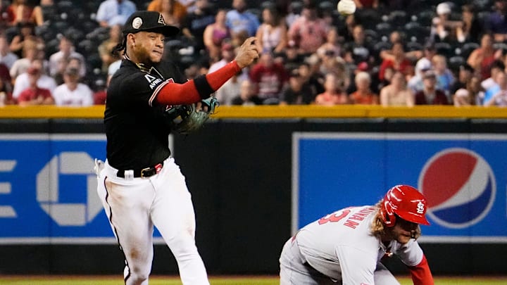 Jul 24, 2023; Phoenix, AZ, USA; Arizona Diamondbacks second baseman Ketel Marte (4) turns a double play over St. Louis Cardinals Brendan Donovan (33) in the third inning at Chase Field. Mandatory Credit: Rob Schumacher-Arizona Republic
