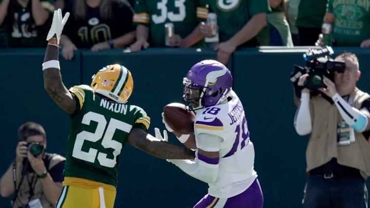 Minnesota Vikings wide receiver Justin Jefferson (18) scores a touchdown on Green Bay Packers cornerback Keisean Nixon (25) during the second quarter of their game Sunday, September 29, 2024 at Lambeau Field in Green Bay, Wisconsin.