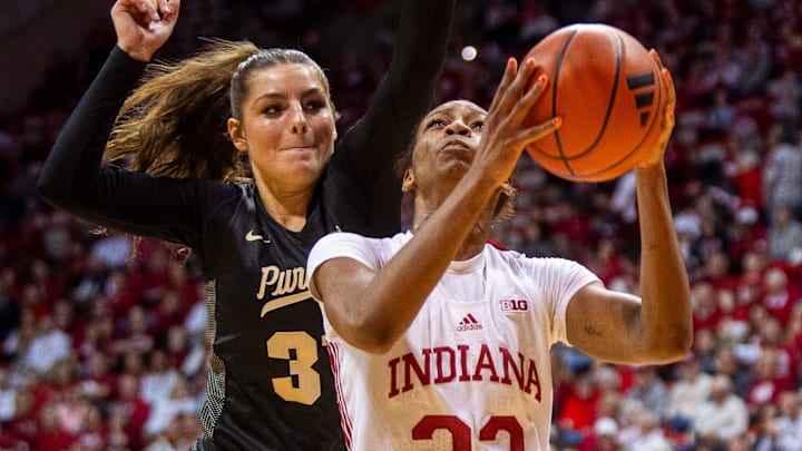 Indiana's Chloe Moore-McNeil (22) scoreas past Prudue's Sophie Swanson (31) during the Indiana versus Purdue women's basketball game at Simon Skjodt Assembly Hall on Saturday, Feb. 15, 2025.