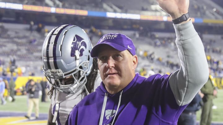 Oct 19, 2024; Morgantown, West Virginia, USA; Kansas State Wildcats head coach Chris Klieman celebrates with fans after defeating the West Virginia Mountaineers at Mountaineer Field at Milan Puskar Stadium. Mandatory Credit: Ben Queen-Imagn Images Oct 19, 2024; Morgantown, West Virginia, USA; Kansas State Wildcats head coach Chris Klieman celebrates with fans after defeating the West Virginia Mountaineers at Mountaineer Field at Milan Puskar Stadium. Mandatory Credit: Ben Queen-Imagn Images