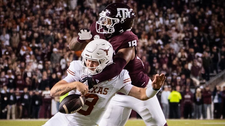 Nov 30, 2024; College Station, Texas, USA; Texas Longhorns quarterback Quinn Ewers (3) is sacked by Texas A&M Aggies defensive lineman Cashius Howell (18) in the third quarter of the Lone Star Showdown at Kyle Field. Mandatory Credit: Sara Diggins/USA TODAY Network via Imagn Images