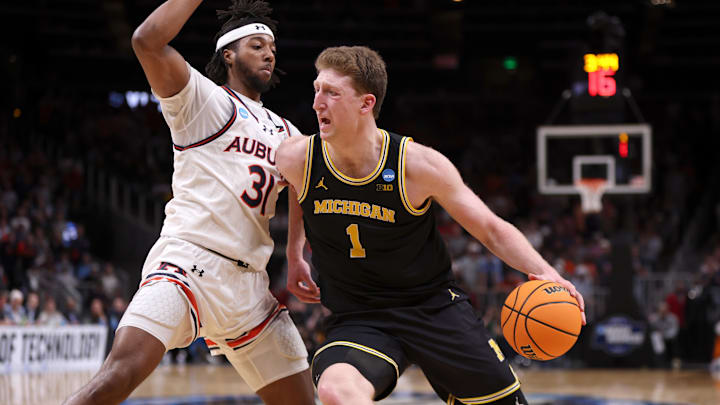 Mar 28, 2025; Atlanta, GA, USA; Michigan Wolverines center Danny Wolf (1) drives against Auburn Tigers forward Chaney Johnson (31) in the second half of a South Regional semifinal of the 2025 NCAA tournament at State Farm Arena. Mandatory Credit: Brett Davis-Imagn Images Mar 28, 2025; Atlanta, GA, USA; Michigan Wolverines center Danny Wolf (1) drives against Auburn Tigers forward Chaney Johnson (31) in the second half of a South Regional semifinal of the 2025 NCAA tournament at State Farm Arena. Mandatory Credit: Brett Davis-Imagn Images